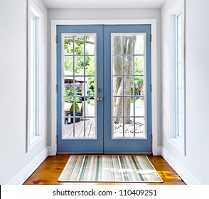Double patio french doors with windows exiting to sunny backyard