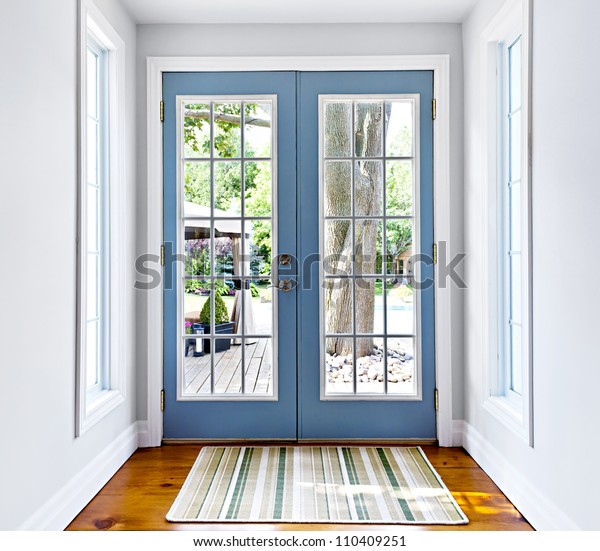 Double patio french doors with windows exiting\
to sunny backyard
