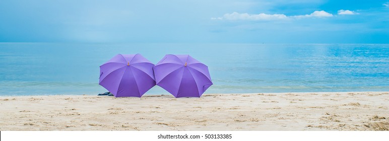 Double Purple Umbrella On The Beach