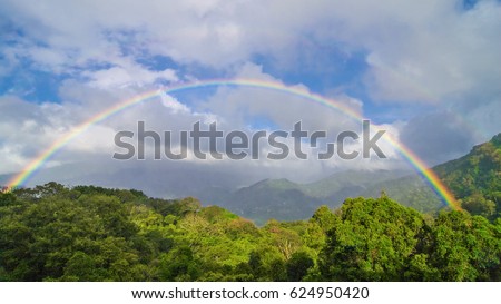 Double rainbow, clouds, and tropical forest background in Boquete, Panama.