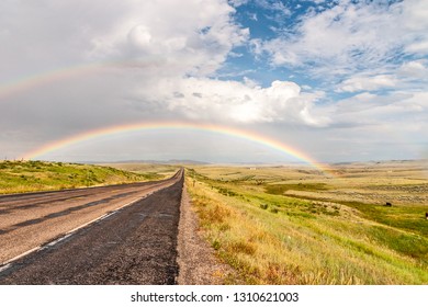 Double Rainbow Crossing A Road And Ending In A Field With Cows