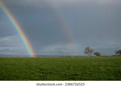 Double rainbow in the distance on a showery day - Powered by Shutterstock