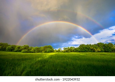 Double rainbow during the coming storm over the Czech green spring landscape