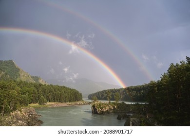 Double Rainbow. River And Mountain Landscape. Green Trees. LGBT Symbol. Pride Month Travel Sunset. No People Scene. Outdoor Hill