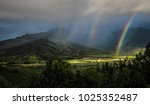 Double rainbow and sunbeams illuminate the taro fields at Kauai