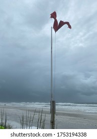 Double Red Flags Flying Fiercely On The Beach As Tropical Storm Cristobal Approaches