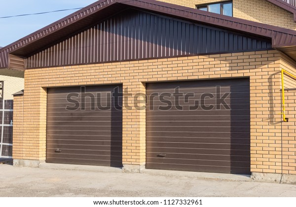 Double roller shutters\
in a brown garage