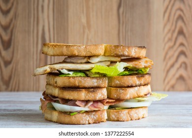 Double Sandwich Of Chicken Avocado And Lettuce And The Other One Of Bacon Avocado Lettuce And Onion