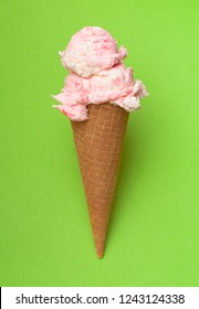 Double Scoop of Strawberry Ice Cream in a Waffle Cone on a Green Background - Shutterstock ID 1243124338