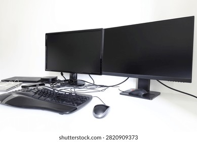 Double screen monitors with computer, keyboard and mouse. Home workdesk concept.