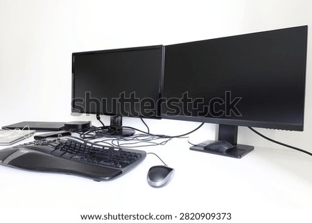 Double screen monitors with computer, keyboard and mouse. Home workdesk concept.