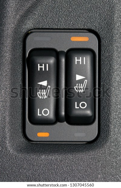 Double seat heating switch in a car, high and low\
heating mode active