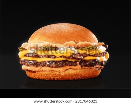 double smash burger with ultra crisp cheddar on black background.