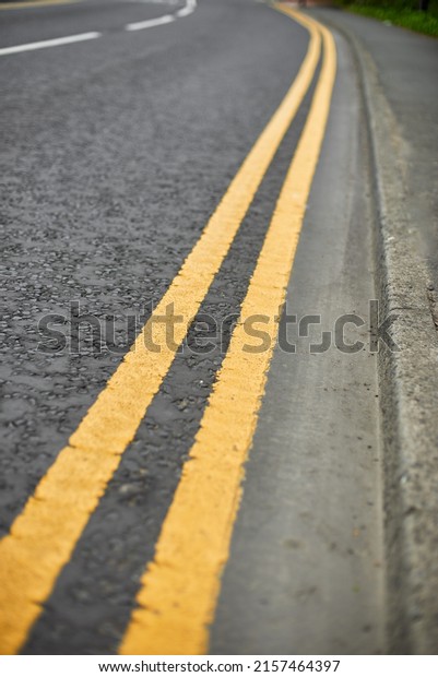 Double solid line of road markings\
in yellow. Perfectly clean border. Yellow road\
markings.