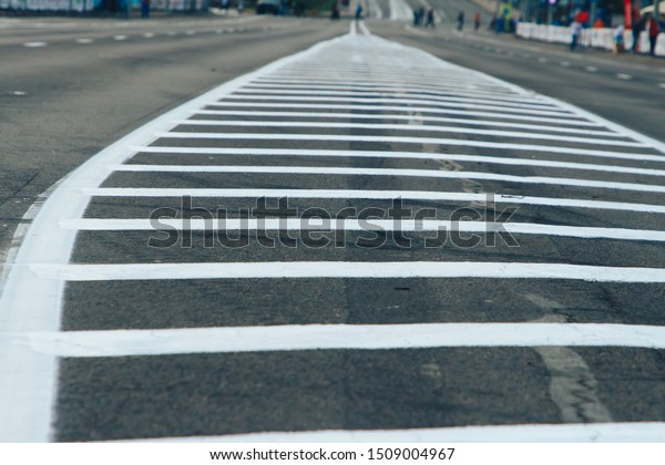 Double solid strip on the road. The prospect of a\
close-up road. Two white stripes on the asphalt. Separation bars on\
the track.