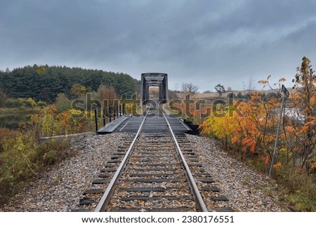 Double span riveted railway truss bridge built in 1893 crossing the Mississippi river in autumn in Galetta, Ontario, Canada