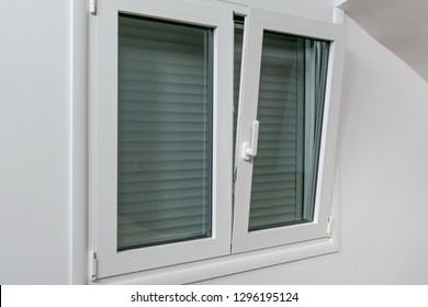 Double tilt and turn aluminum thermal break window with vertical fly screen and rolling shutter, casement window with European groove mechanism - Shutterstock ID 1296195124