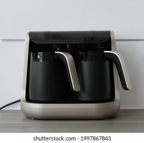 Double Turkish Coffee Machine On Wooden Table. Black Coffee Machine On White Background.