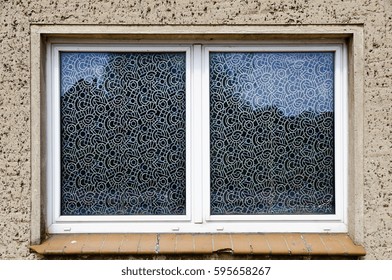 double window with panes plastered with patterned film
