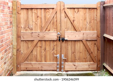 Double wooden driveway gates with locking bolt and drop bolts