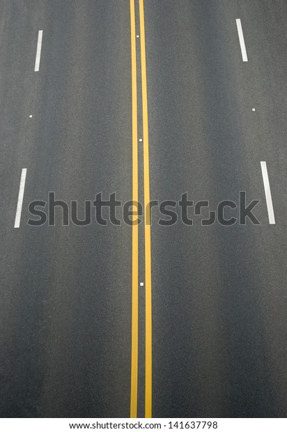 double
yellow lines and white lines divider on
blacktop