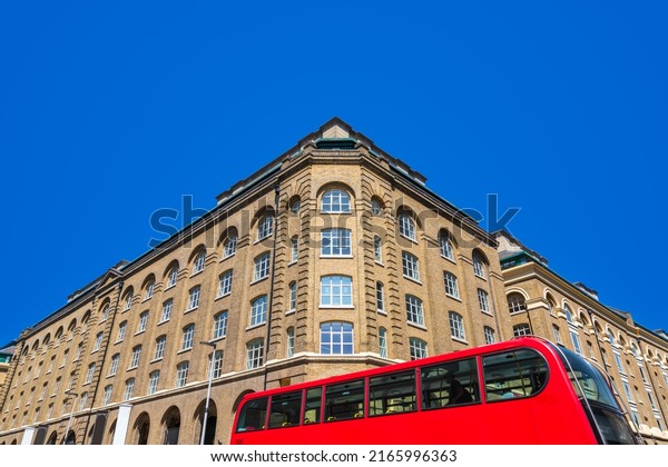 A double-decker bus moving past\
Hay\'s Galleria in Southwark, London seen from Tooley\
street