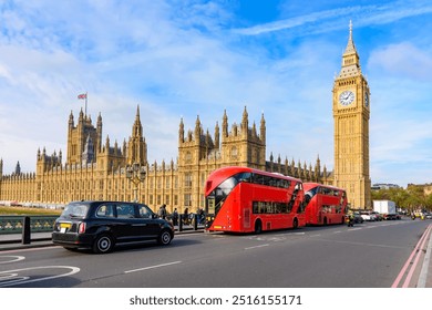 Double-decker buses and black cab on Westminster bridge with Big Ben and Houses of Parliament at background, London, UK