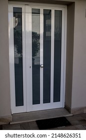 Double-leaf front door made of metal-plastic with glass panels