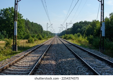 A double-track railway line with an electric traction line - Shutterstock ID 2254374375