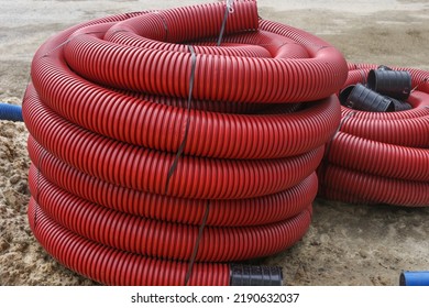 Double-walled Corrugated Pipes With Soft Broach In CoilsHDPE Corrugated Pipe With Double Wall Strength At The Construction Site. Used To Protect Underground Cable.