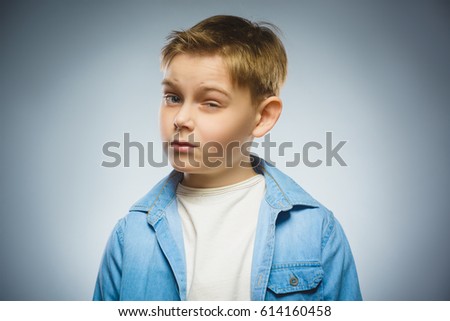 doubt, expression and people concept - boy thinking over gray background