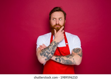 doubter isolated chef with beard and red apron - Powered by Shutterstock