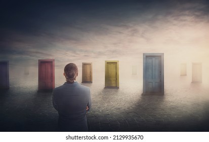 Doubtful businessman in front of multiple doors of diverse colors as symbol for different opportunities. Business challenge, choosing a correct doorway. Difficult decision concept, failure or success