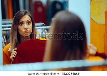 
Doubtful Client Trying on a Red Sweater in a Fashion Store Mirror
Unhappy customer having a negative shopping experience 

