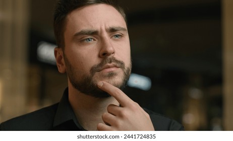 Doubtful thoughtful Caucasian man businessman portrait male guy entrepreneur think deep thoughts brainstorm hold hand on chin question choosing decision search answer imagine dream thinking in office - Powered by Shutterstock