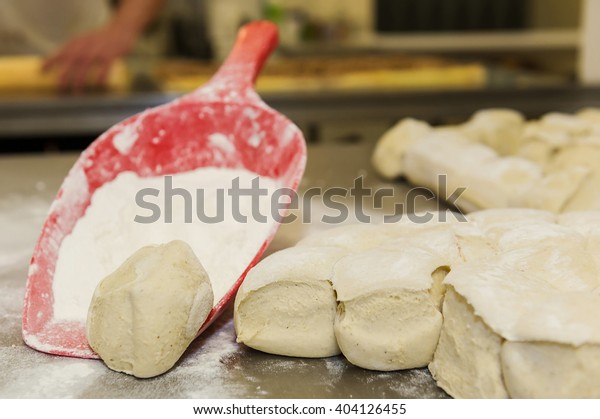Dough balls and red scoop
with flour.