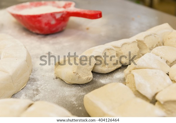 Dough balls and red scoop\
with flour.