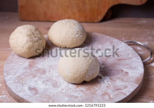 The dough is divided into three parts and formed\
into buns