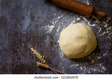 Dough. Fresh Raw Dough Ball For Bread Or Pizza On A Dark Table, Baking Background. Top View Flat Lay Background. Copy Space.