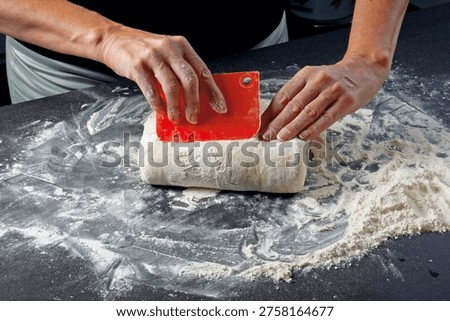 Dough handling – Using a dough scraper, fold the dough in from both sides.
