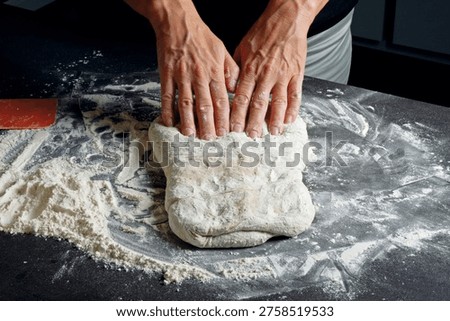 Dough handling – Using the dough scraper, fold the dough in from both sides, slide the scraper underneath and turn it to the other side so that the seam faces down.