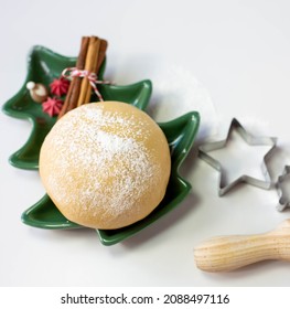 The Dough In The Shape Of A Ball Is On A Decorative Plate In The Shape Of A сhristmas Tree Out Of Focus And Bakeware Is On A Light Background. View From The Top Point.