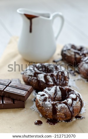 Doughnuts, a bar of chocolate and a jug, selective focus