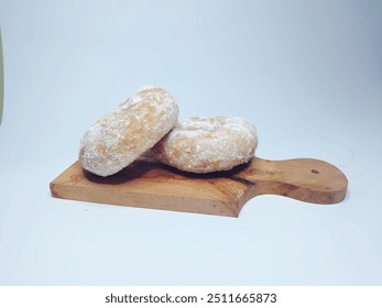 Doughnuts sprinkled with powdered sugar on a wooden tray isolated on a white background - Powered by Shutterstock