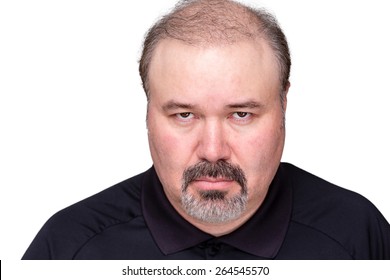 Dour angry middle-aged man glowering at the camera from under his brows, head and shoulders isolated on white - Shutterstock ID 264545570