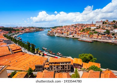 Douro river and local houses with orange roofs in Porto city aerial panoramic view. Porto is the second largest city in Portugal.