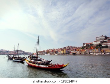 Douro riverside and boats with wine barrels, Porto, Portugal. Vintage picture