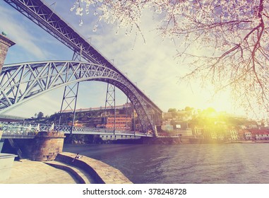 Douro riverside with the Dom Luiz bridge at spring , Porto , Portugal. Vintage colored picture Travel background