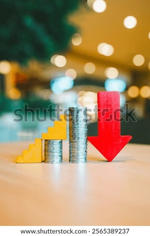 Down arrow with coin stack. concepts for success, methods, systems of raising or lowering Fed interest rates to correct inflation concepts.