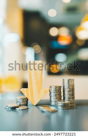 Down arrow with coin stack. Key concepts for success, methods, systems of raising or lowering Fed interest rates to correct inflation concepts.